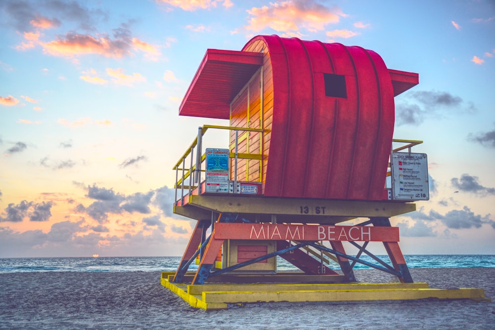 red and white lifeguard house on beach during daytime