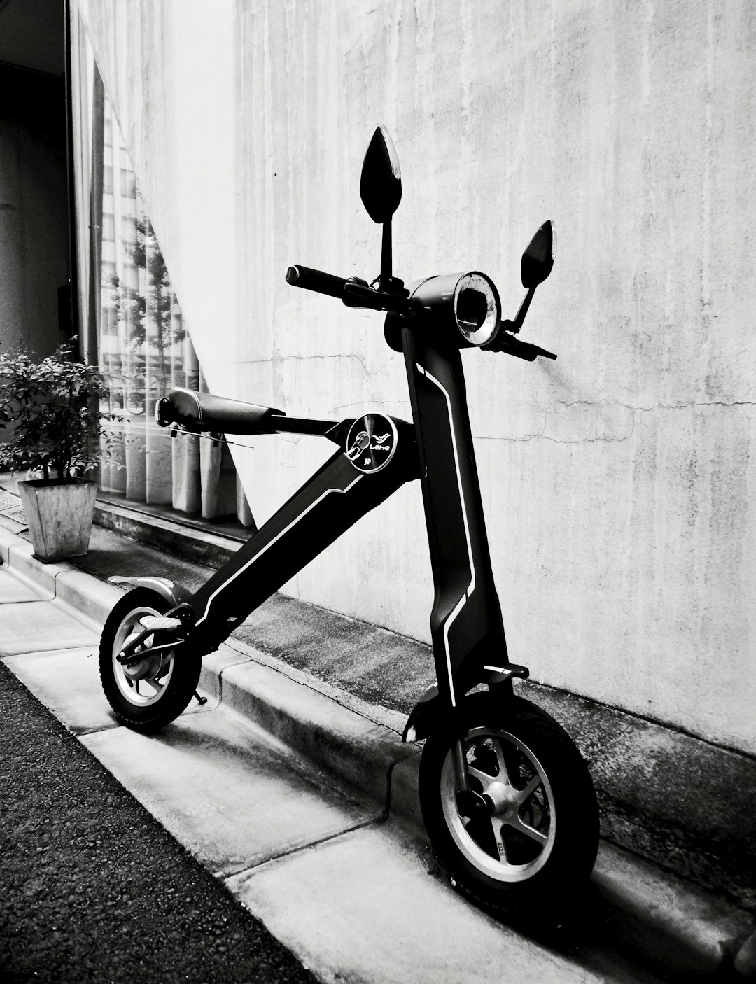 black and gray bicycle with training wheels