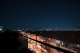 Night view of a city skyline highlighting properties managed by Stax Properties LLC.