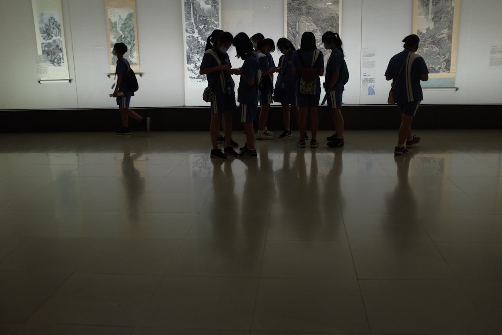 group of people standing on white floor tiles