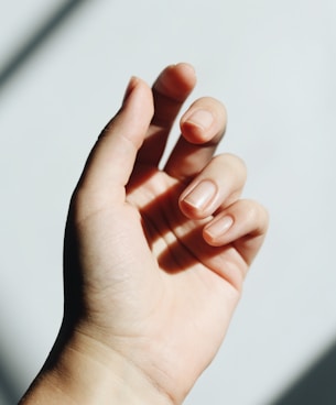 persons left hand on white table