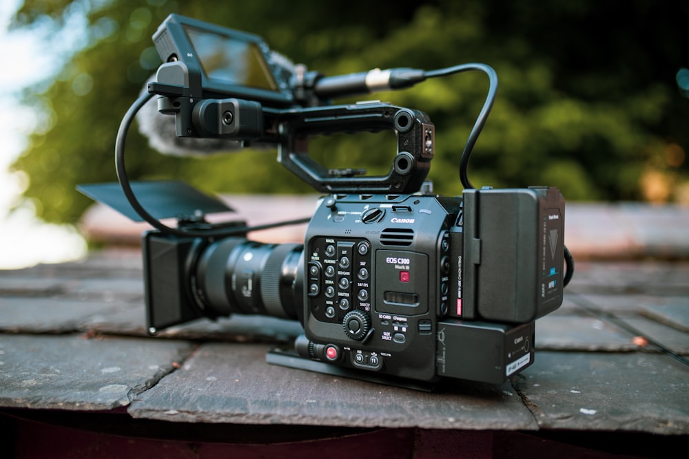 black dslr camera on brown wooden table