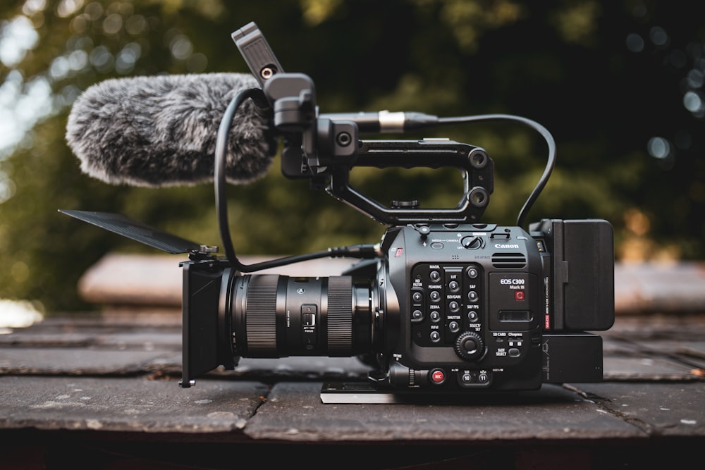 black dslr camera on brown wooden table