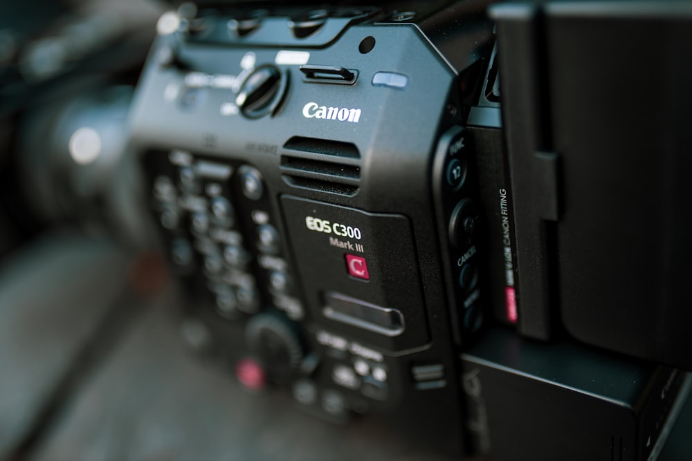 black canon dslr camera on black table