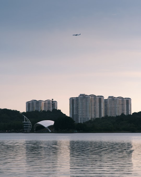 white and black boat on sea near city buildings during daytime in Putrajaya Malaysia