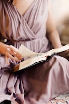 person in white dress shirt reading book