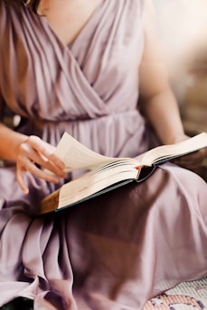 person in white dress shirt reading book