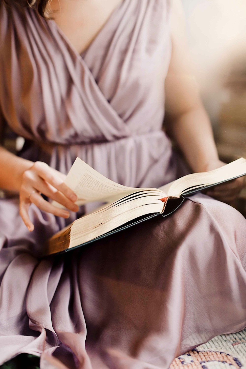 person in white dress shirt reading book