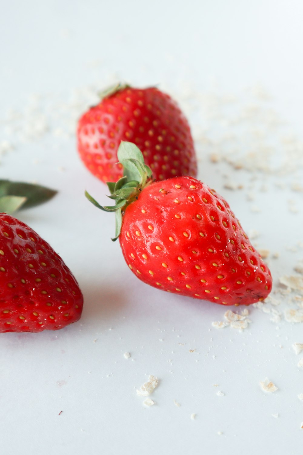 red strawberry on white surface