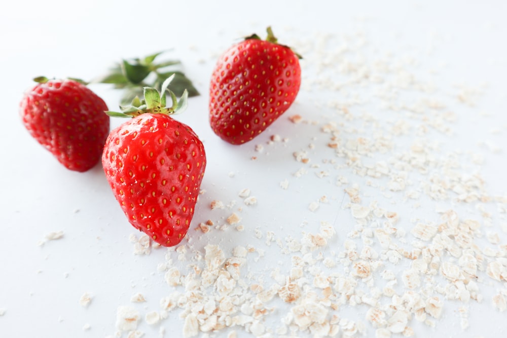 red strawberry on white sand