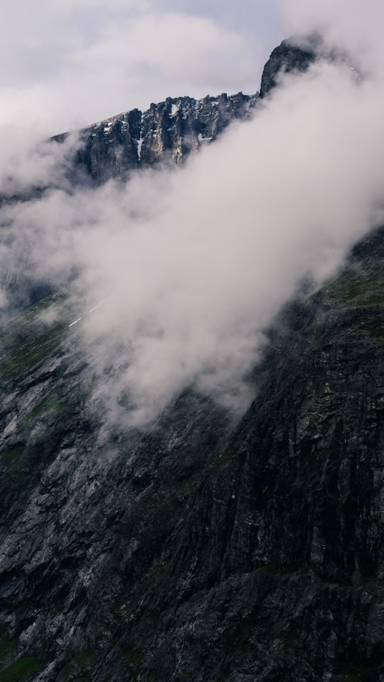 gray and green mountain with white clouds in Trollstigen Norway
