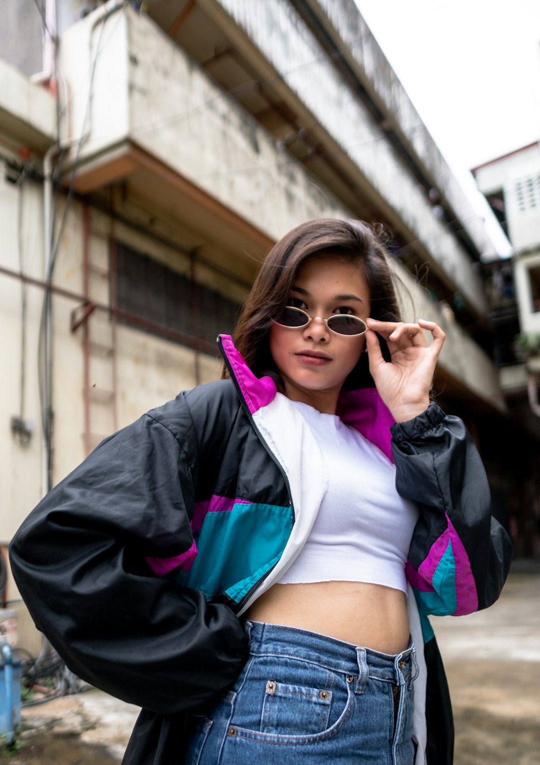 woman in white crop top and black jacket wearing sunglasses