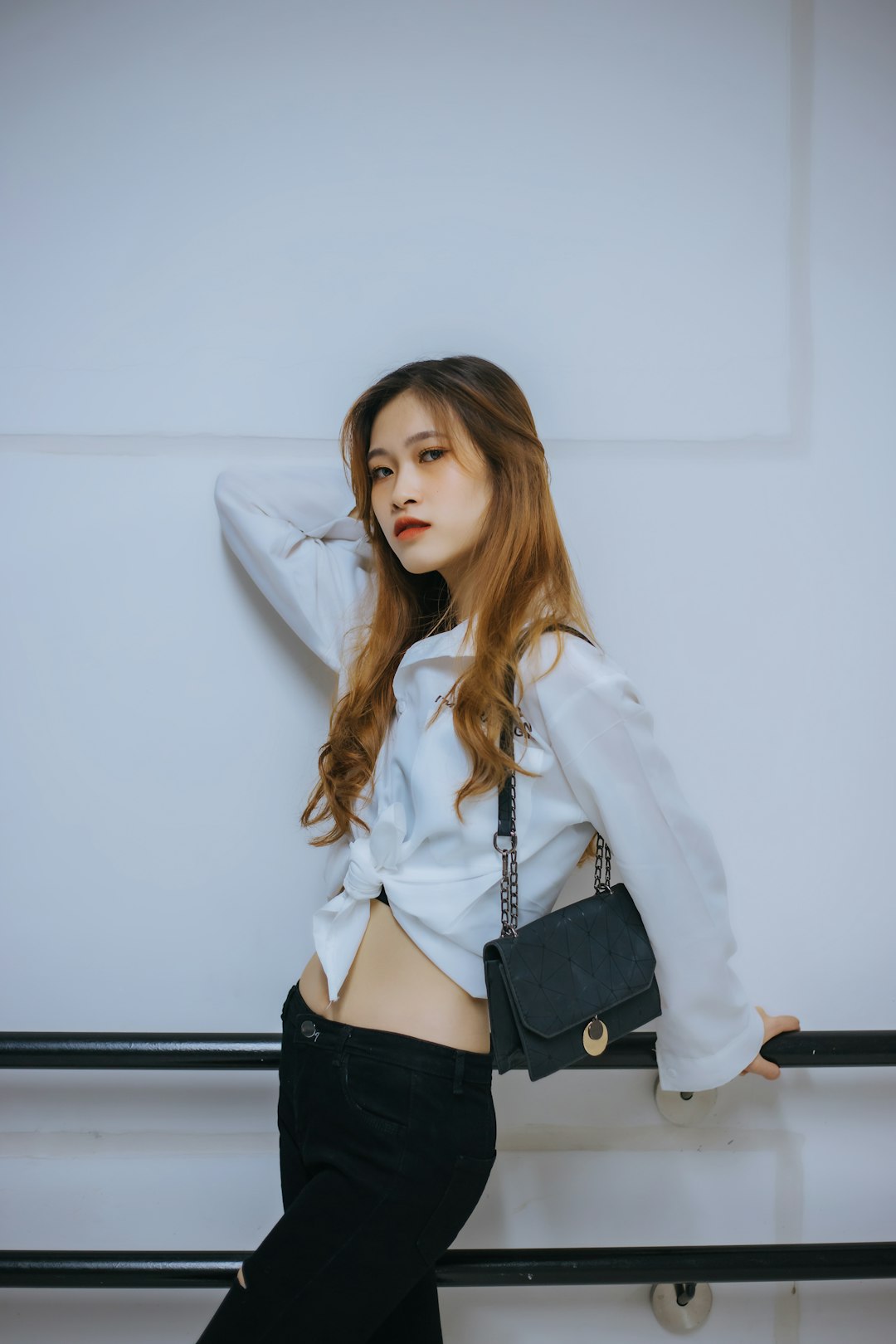 woman in white coat and black leather belt