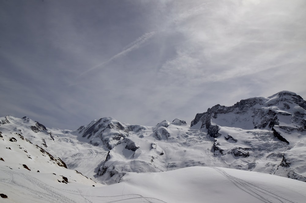 snow covered mountain under cloudy sky during daytime