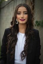 woman in black blazer smiling