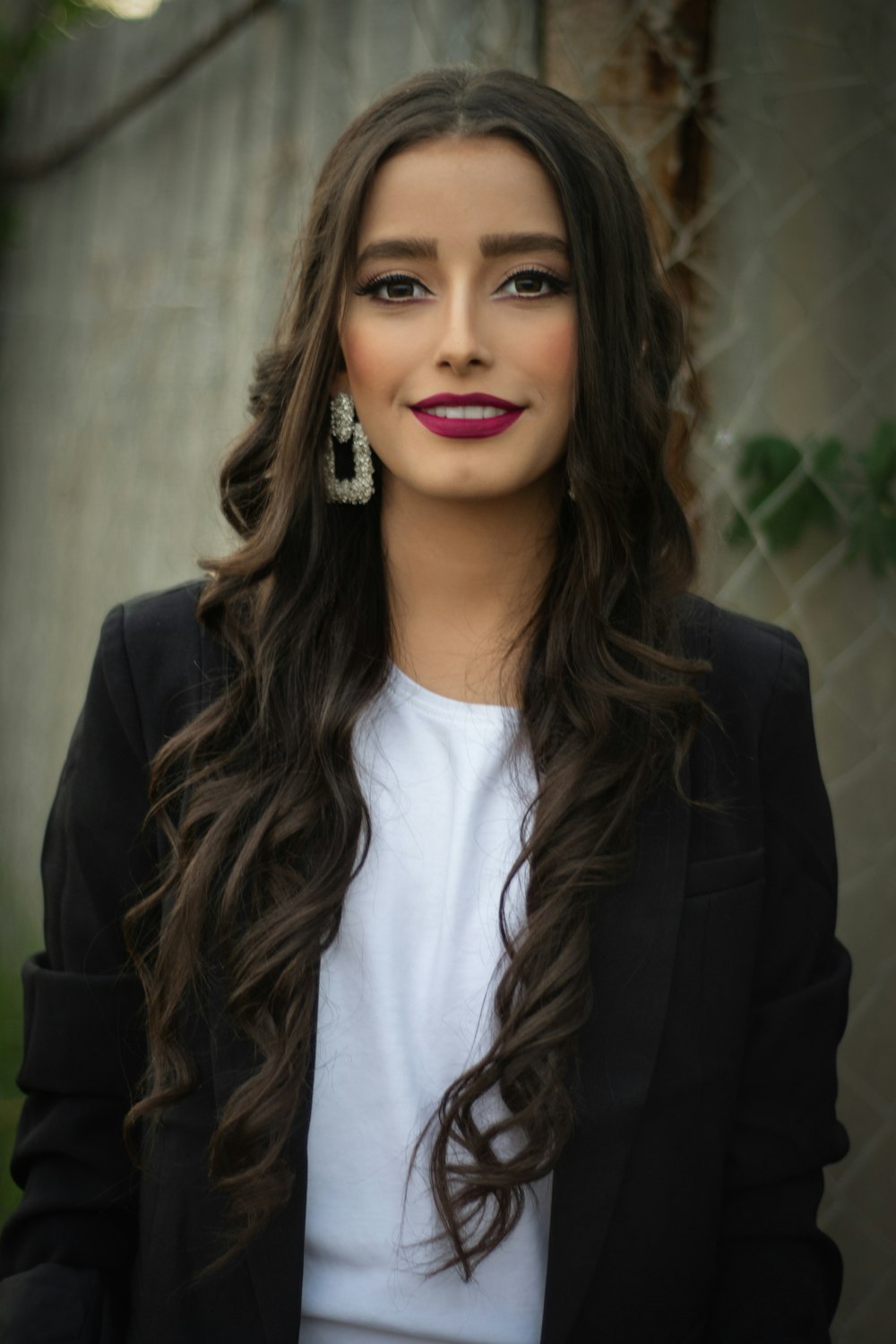 woman in black blazer smiling