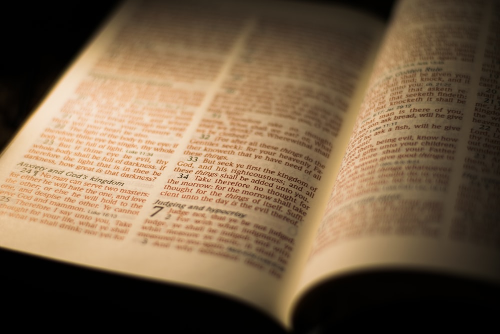 opened book on brown wooden table