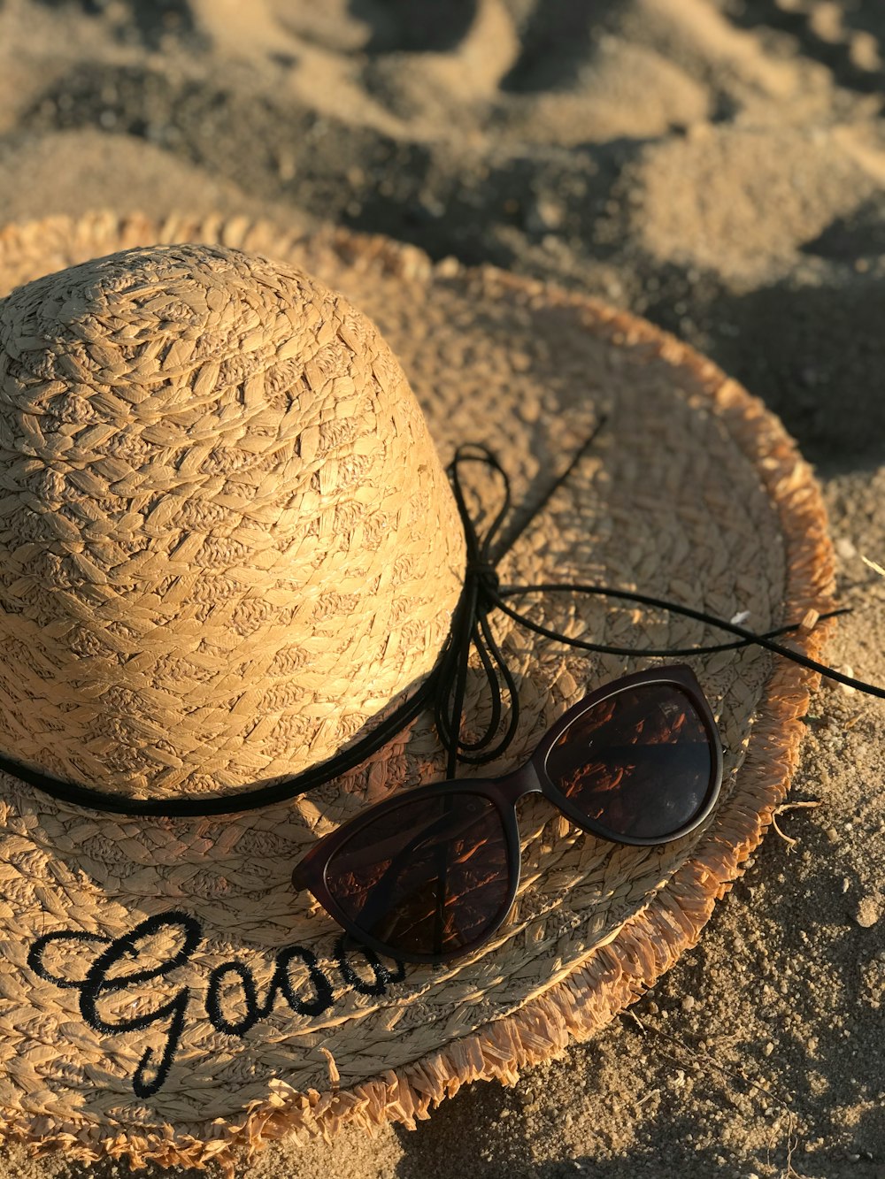 black framed sunglasses on brown sun hat