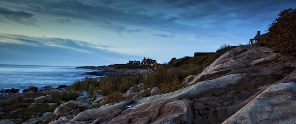 a lighthouse on a rocky cliff overlooking the ocean