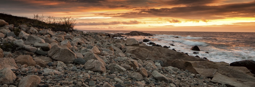 a rocky beach with waves crashing on the shore