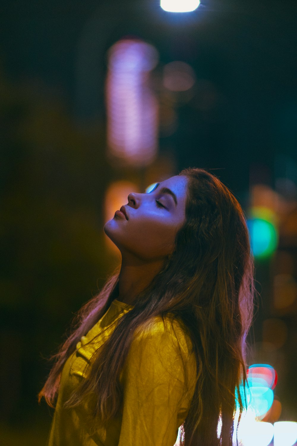 woman in yellow shirt looking up