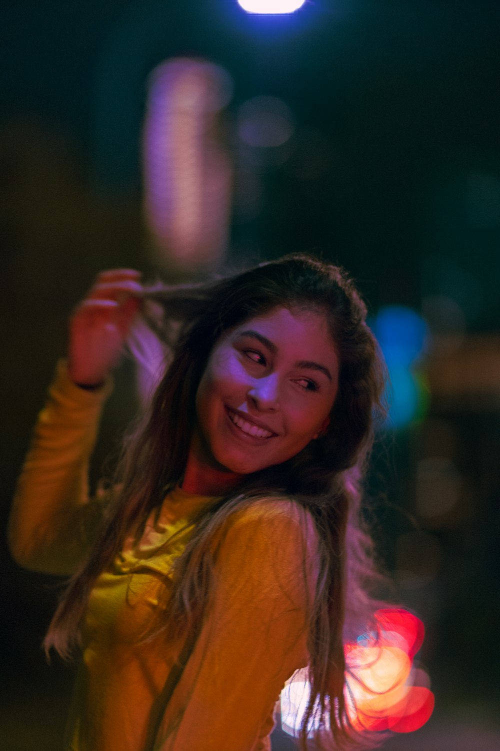 woman in yellow long sleeve shirt smiling