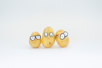 3 yellow fruits on white surface potato teams background