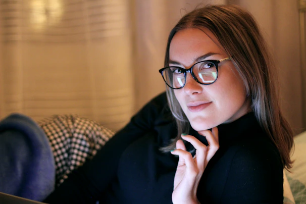 A cozy scene of a person lounging in soft, casual clothes with warm natural light.