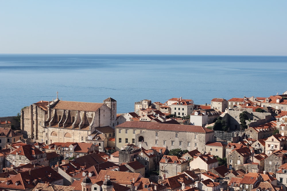 brown and white concrete houses near sea during daytime