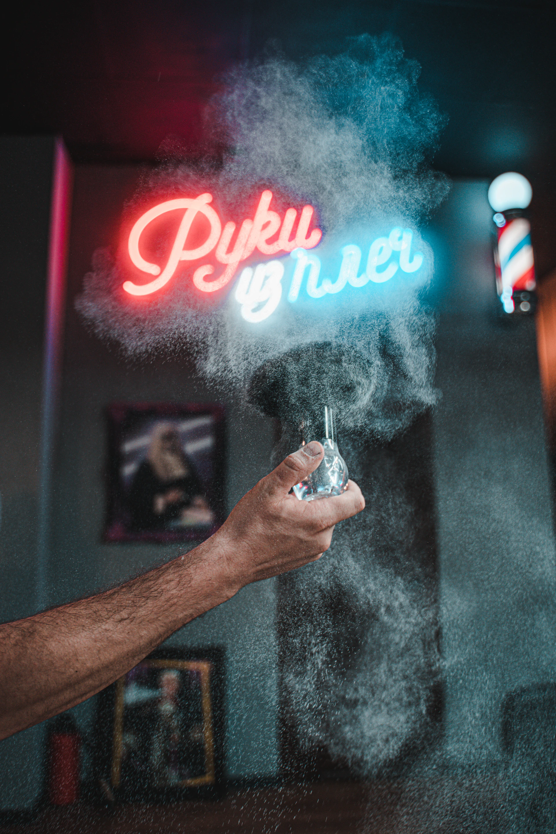 person holding silver and black tube type vape