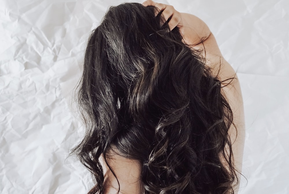 the back of a woman's head with long dark hair