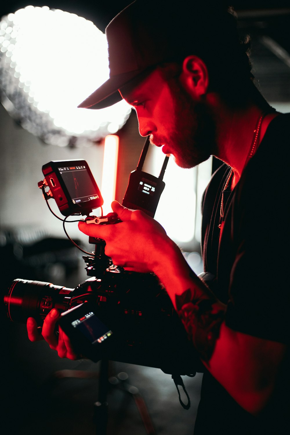 man in black and red long sleeve shirt holding black video camera