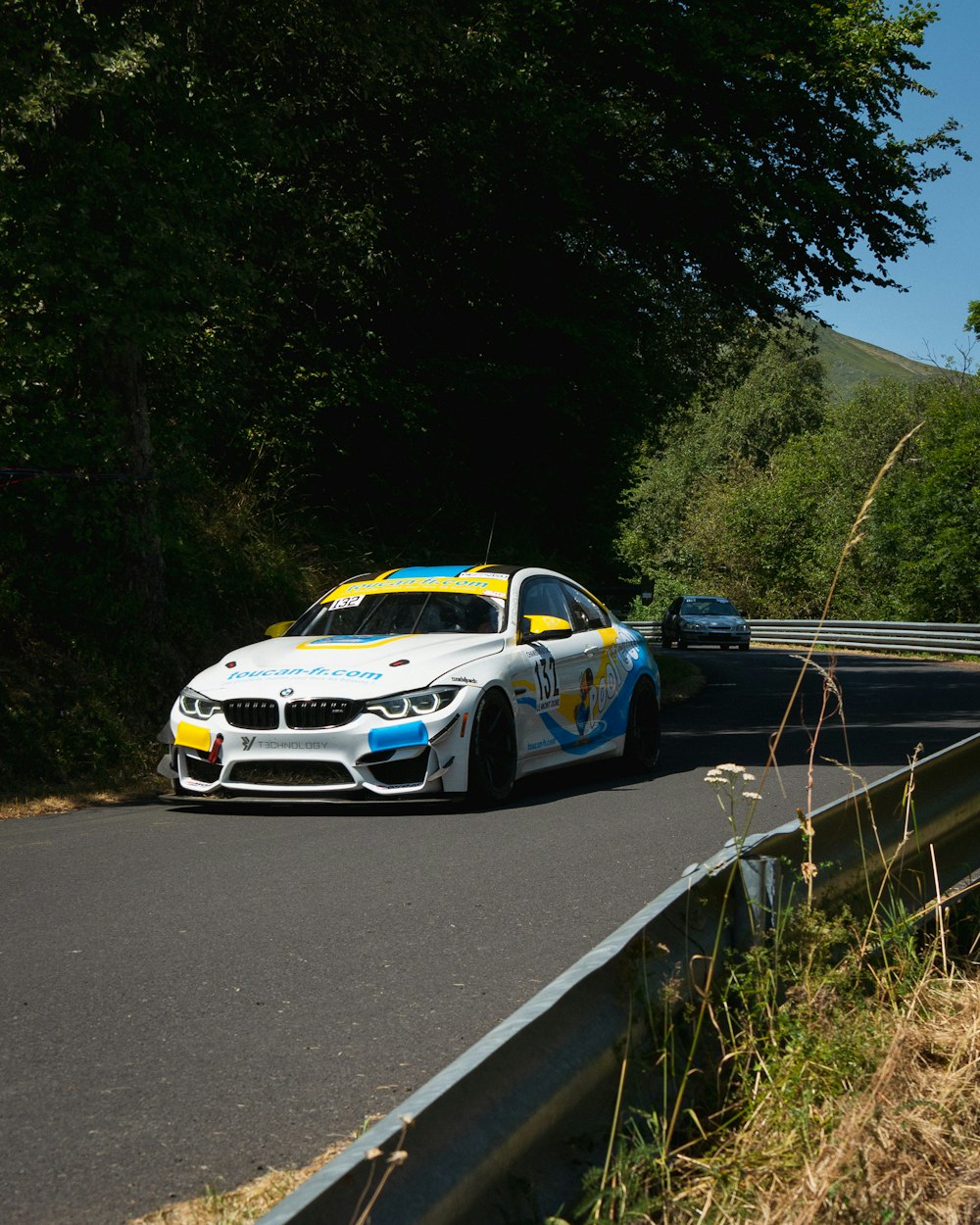 white and blue porsche 911 on road during daytime