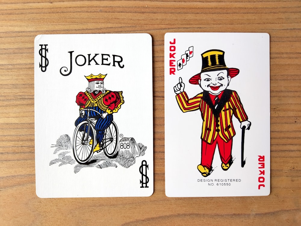 joker playing card on brown wooden table