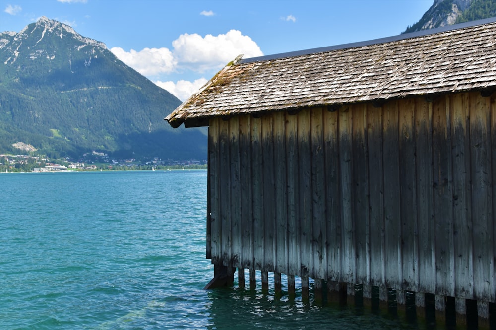 brown wooden house on sea during daytime