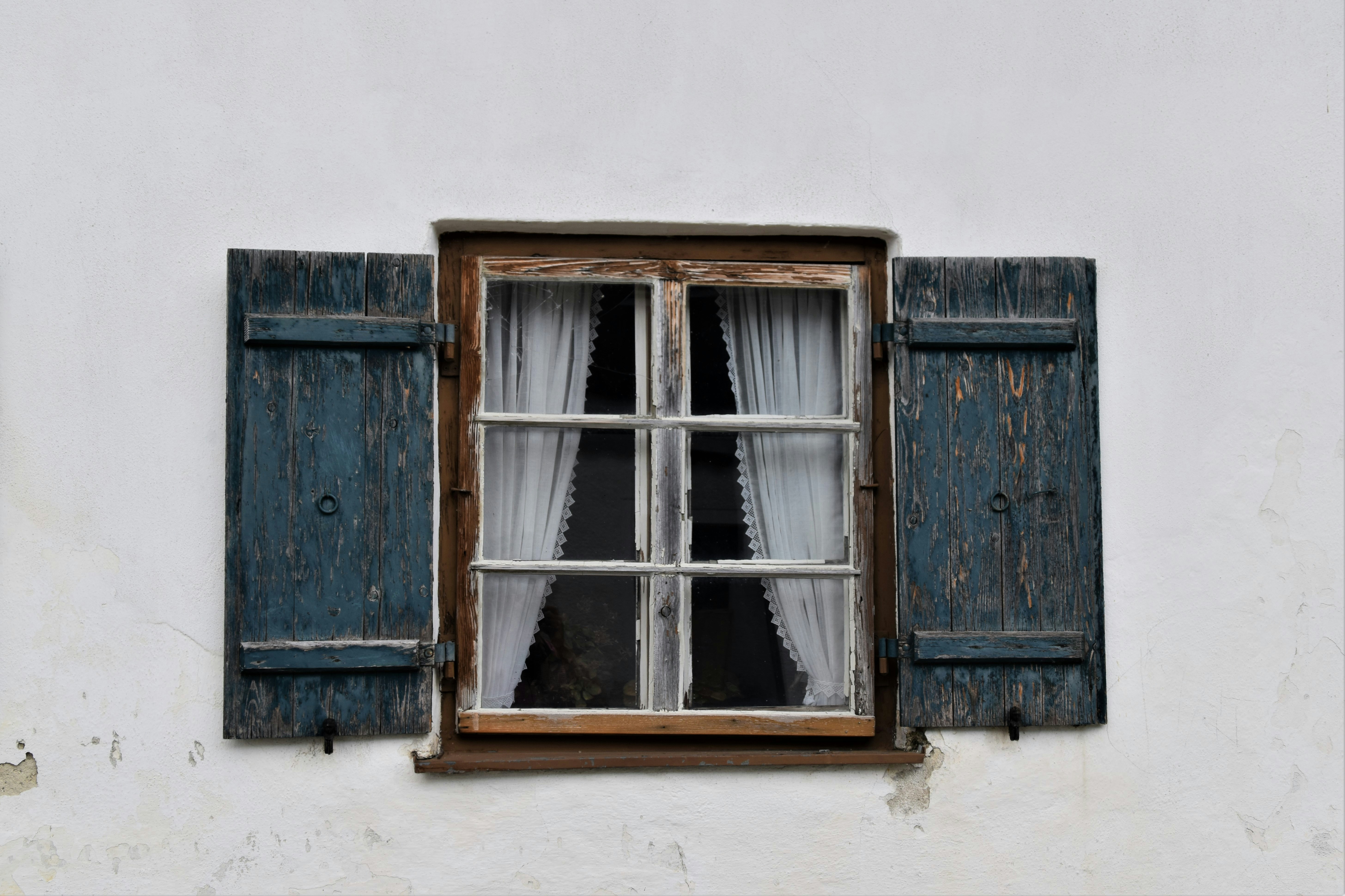 brown wooden window frame on white concrete wall
