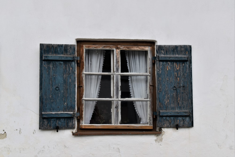 brown wooden window frame on white concrete wall