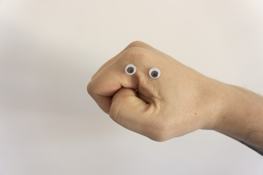 person holding brown heart shaped bread