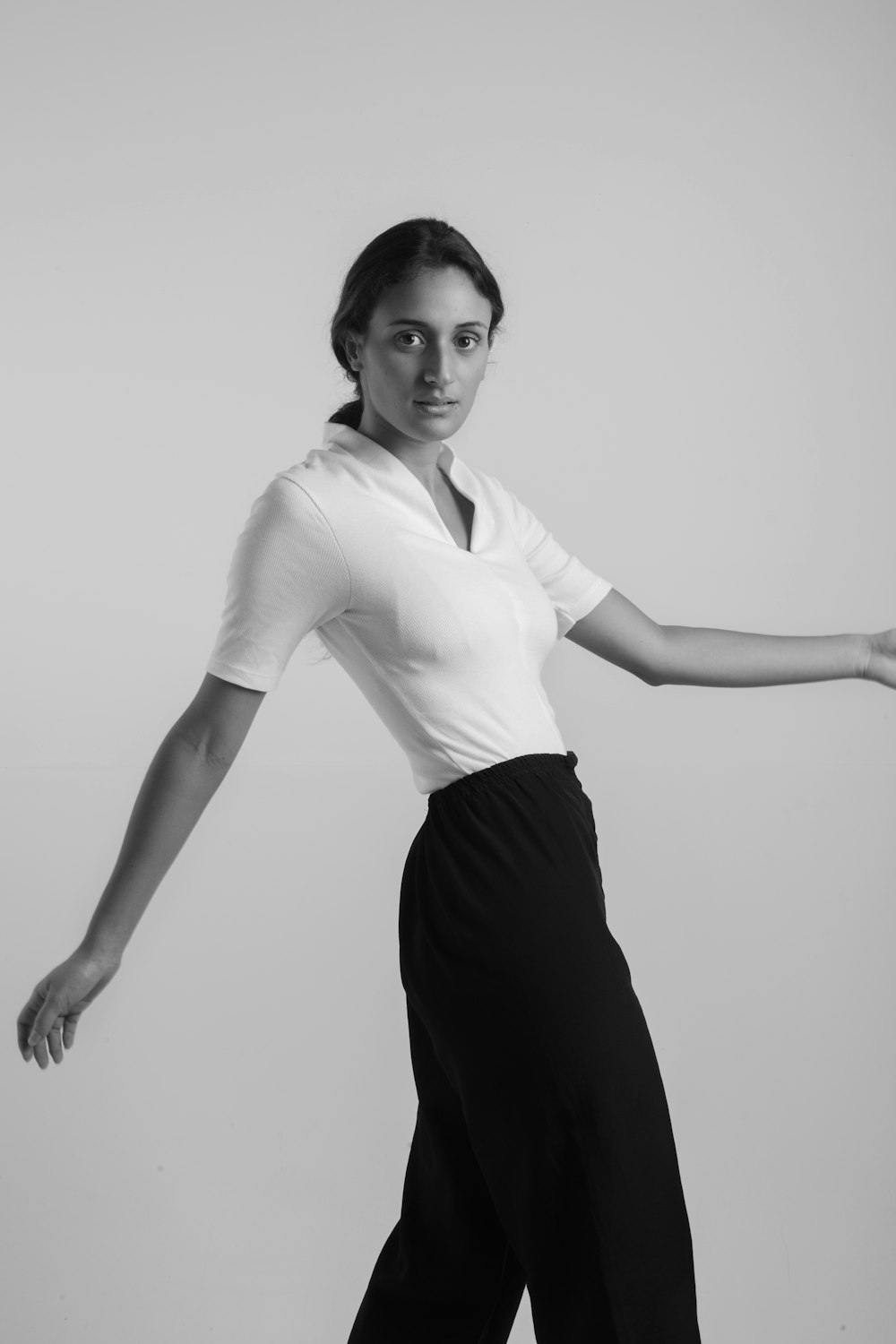 grayscale photo of woman in white long sleeve shirt and black skirt