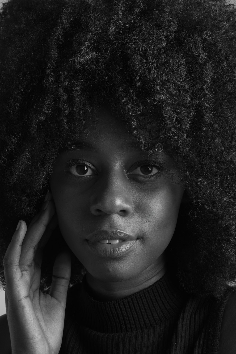 grayscale photo of woman with curly hair