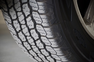 Side view of a large truck tire showing worn but usable tread.