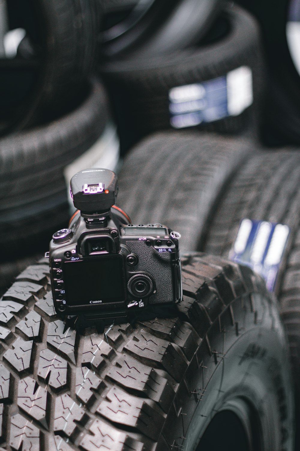 black dslr camera on white and black textile