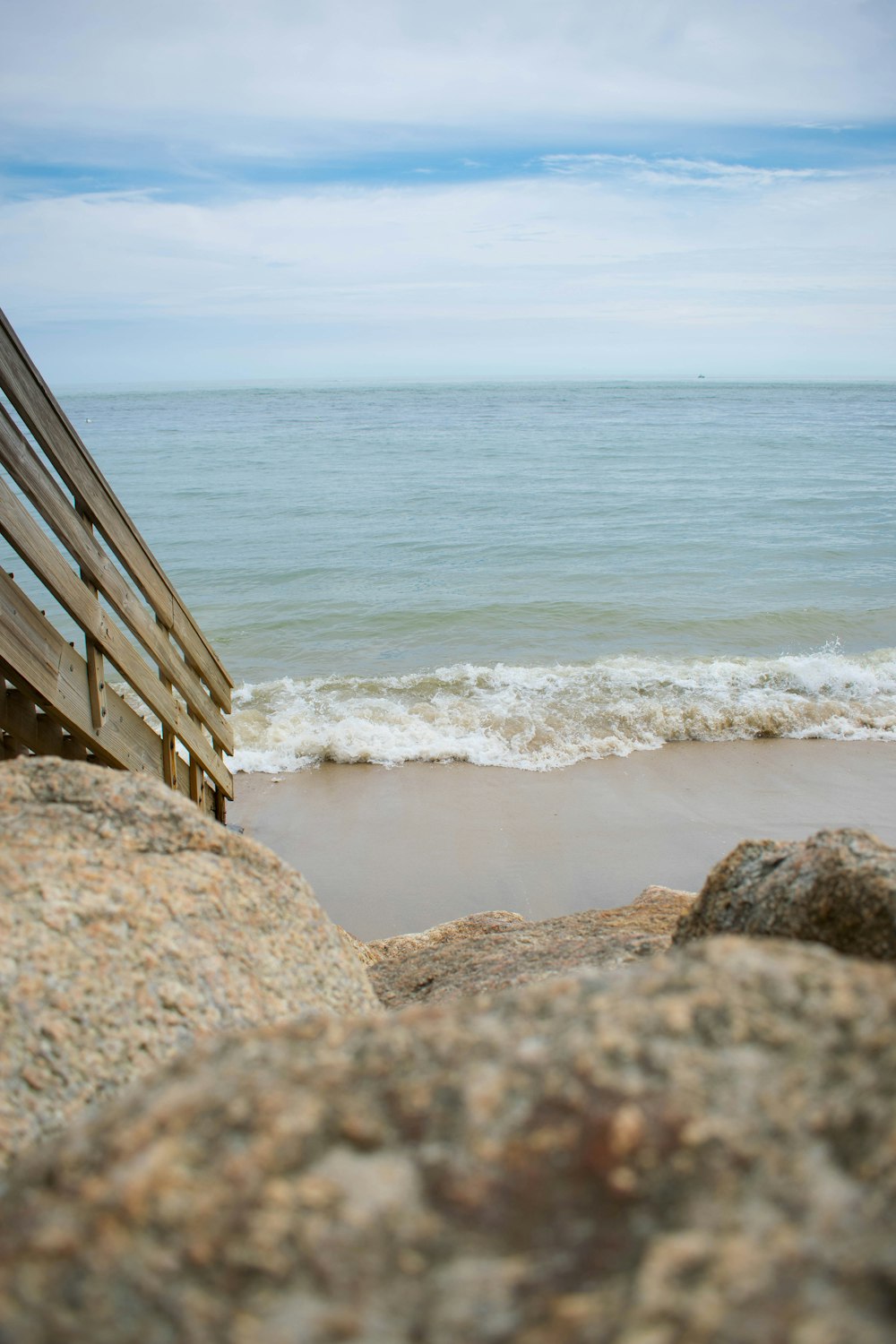 brown wooden stairs on beach during daytime