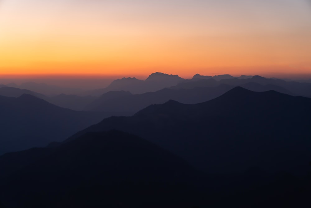 silhouette of mountains during sunset