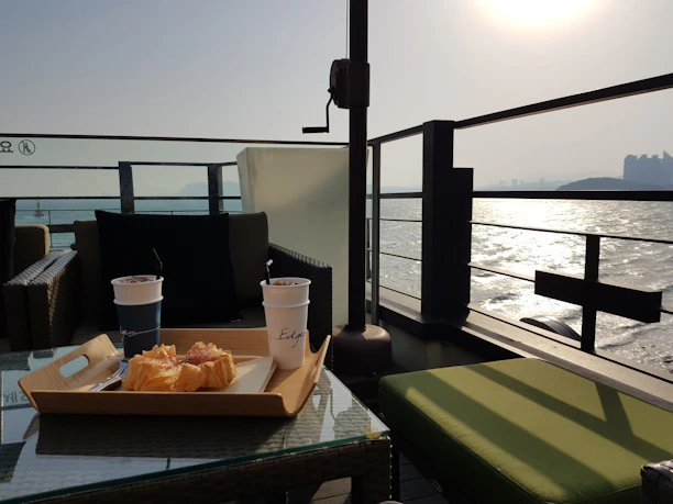 Happy guests enjoying a sunny morning coffee on the terrace house patio.
