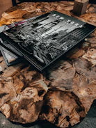 Cover images of recently published humanities books on a wooden table.