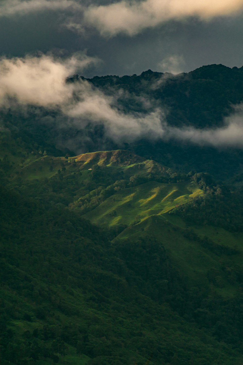 green mountains under white clouds during daytime