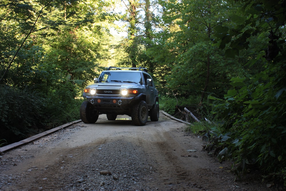 black chevrolet crew cab pickup truck parked on dirt road