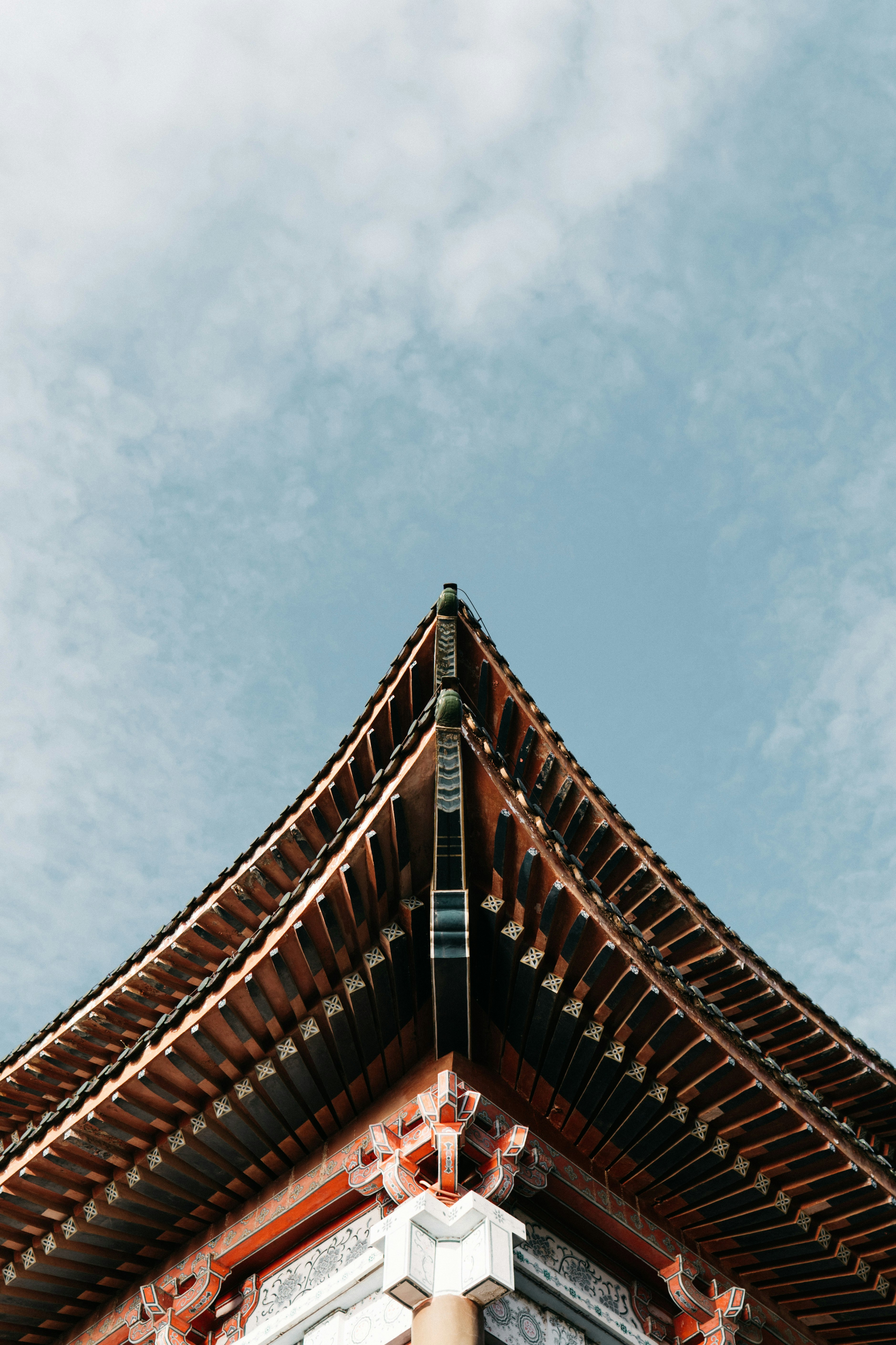 red and black roof under blue sky