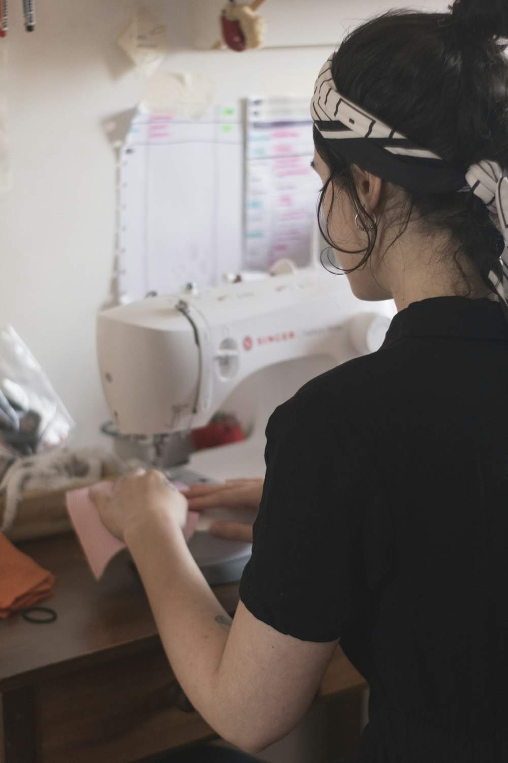 man in black shirt using sewing machine